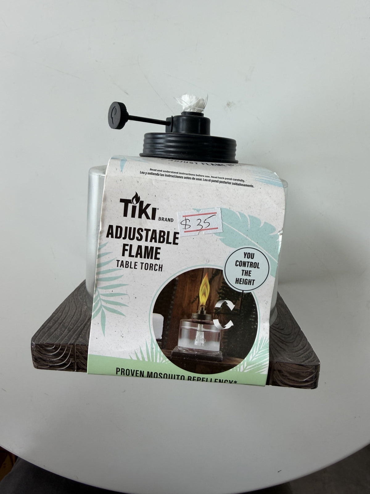 TIKI Brand Adjustable Flame Glass Table Torch — Clear glass; dark geometric base